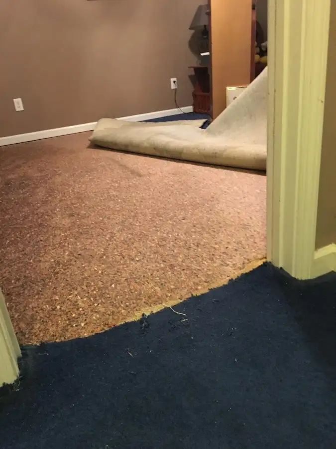 Carpet pad removal revealing water damage during Water Mitigation Services in Orcutt